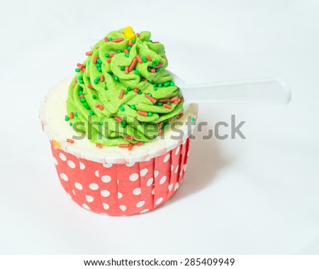 green cupcake with blur spoon on white background