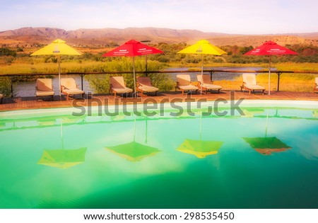 Noordoewer , South Africa - May 2, 2015: View at swimming pool and Orange river in Felix Unite Camp in Noordoewer, South Africa.