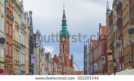 Gdansk, Poland - July 29, 2015: Historic Old Town houses with the town hall on Dluga street of Gdansk in Poland. Old historical buildings along the street are typical of Hanseatic towns in Europe.