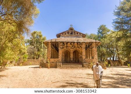 Gondar, Ethiopia - February 9, 2015: Priest in front of Christian church in Gondar, Ethiopia. It was named Debre Birhan Selassie, Trinity and Mountain of Light, and it is historic church.
