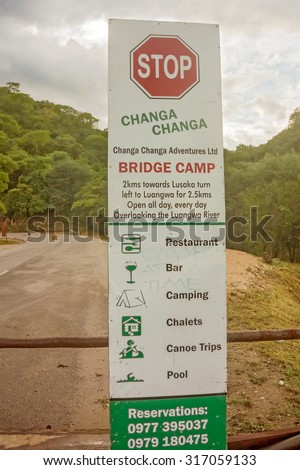Luangwa, Zambia - April 1, 2015: Sign about bridge camp by the road near Luangwa river bridge