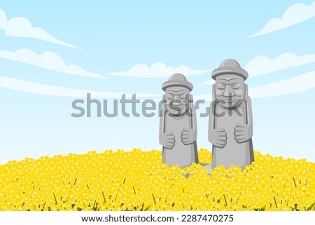 Two Dol hareubang in the middle of canola field