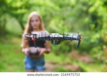 Similar – Image, Stock Photo Little kid operating drone in field