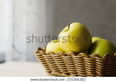 yellow wet fresh apples in a wicker basket