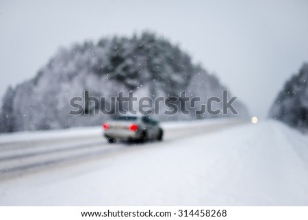 Dangerous blurred highway winter driving. Winter snowy conditions on the highway.