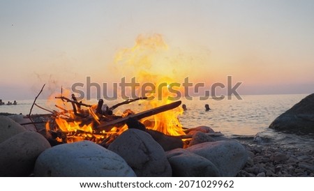 make a fire and swim in the sea at sunset
 Stok fotoğraf © 