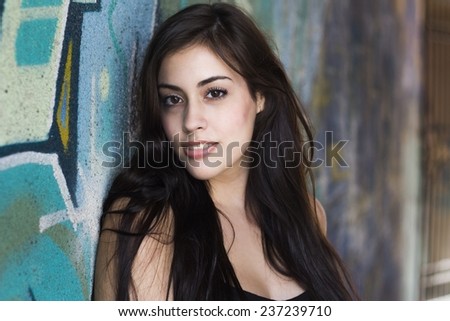 Girl smiling to camera with graffiti background