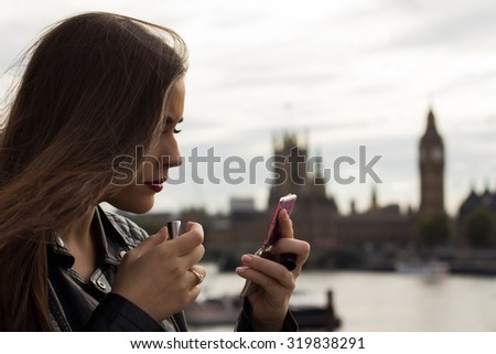 Beautiful woman making up with Big Ben in background