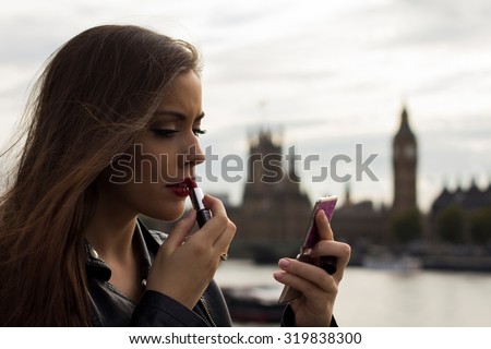 Beautiful woman making up with Big Ben in background