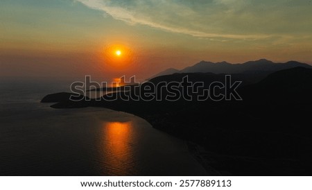 Similar – Image, Stock Photo Scenic sunset over peaceful sea and hilly shores