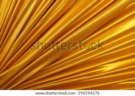 Gold color clothes fabric texture background.