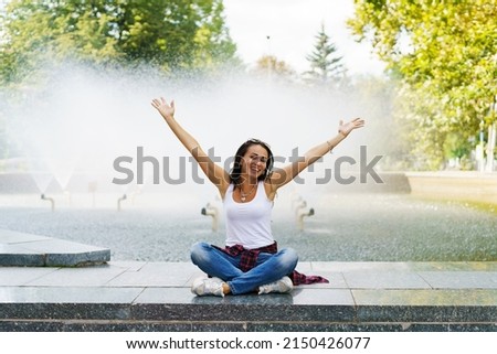 Similar – Image, Stock Photo Cute woman sitting outdoors while using a phone