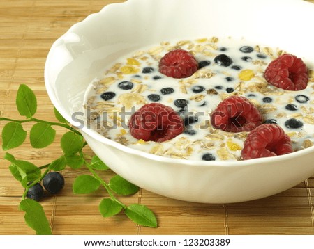 Bowl of milk with fruits and oat flakes