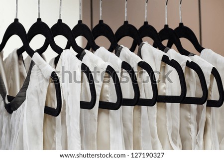 Closeup of dresses hanging on hangers, dressmaker
