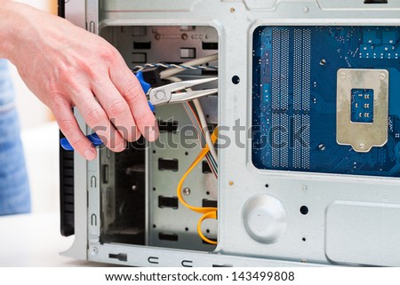 Using pliers to fix a computer