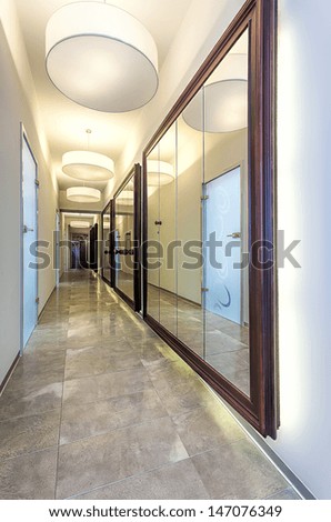Long modern corridor with mirrors on the walls