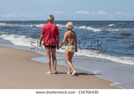 Man and woman walking on the beach
