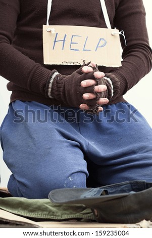 Mendicant on a street begging for help