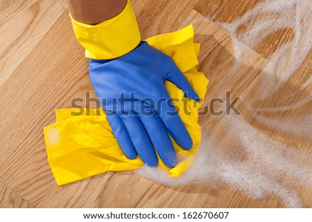 Cleaning the wooden floor by rubber