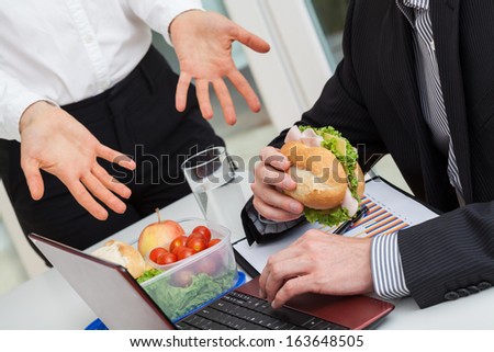 Manager push the employee to finish the meal and work