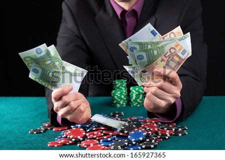 Elegant man in casino wins heap of money
