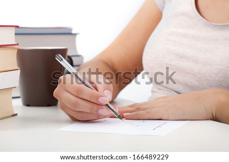 Closeup of a students hands with math notes