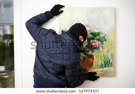 Thief stealing the piece of art from gallery of art.