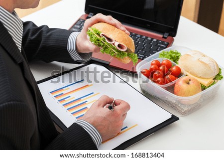 Office worker who are eating sandwich during the job