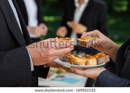 Manager\'s conversations at the office buffet during lunch