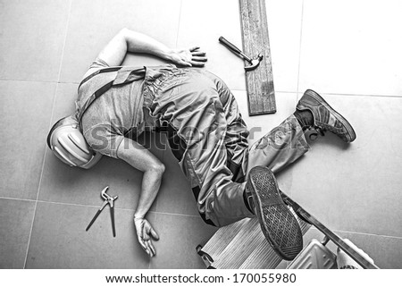 A dead worker on the floor after an accident