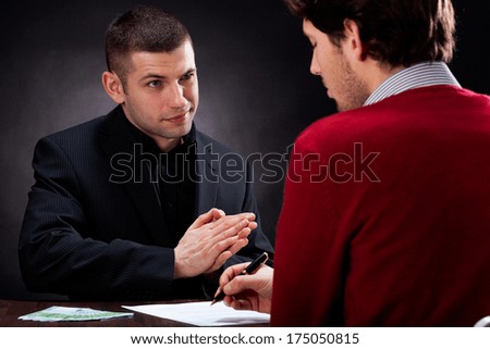Moneylender convincing client to sign usury contract