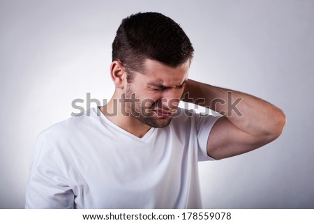 Young man with strong neck pain, horizontal