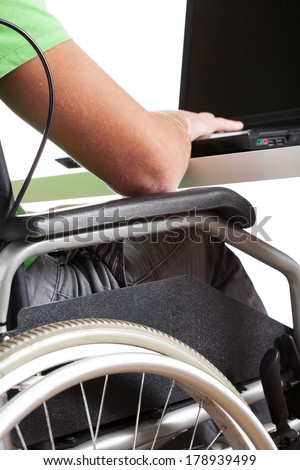 Handicapped man on wheelchair working in office