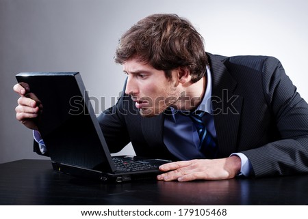 Man staring at screen of his laptop with anxiety