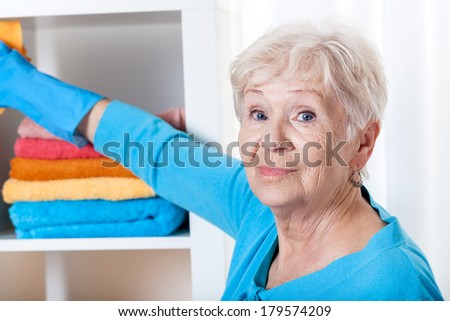 Smiling senior woman during household chores,horizontal