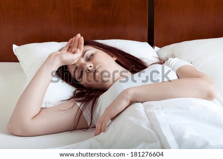 Woman with high fever lying in bed