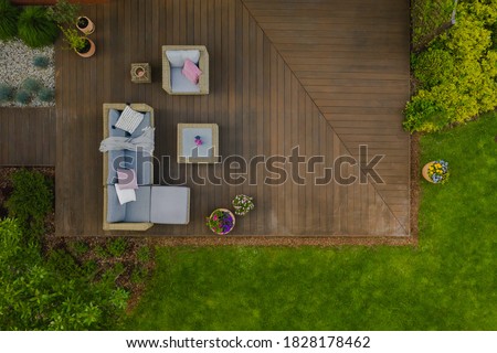 Top view of wooden terrace with comfortable wicker garden furniture
