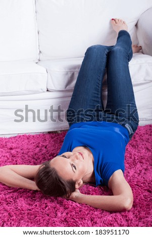 Girl relaxing on a pink fluffy carpet