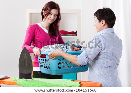 Mother and daughter during sharing house chores