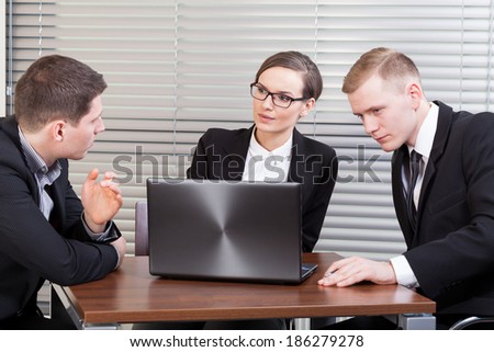 Young managers at business meeting talking about company