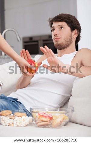 Couch potato preferring junk food instead of apple