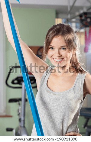 Portrait of a smiling girl with yoga belt