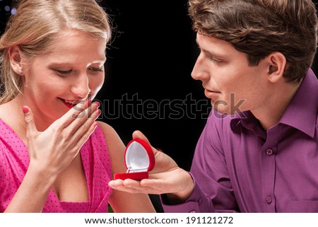 Man asking beauty girl to marry him during romantic evening