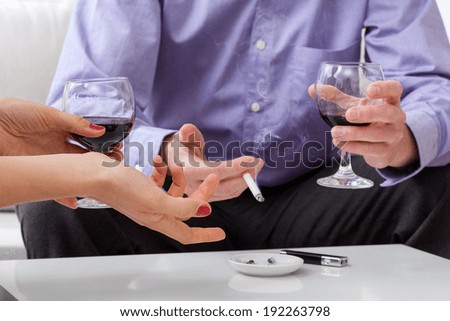 Man and woman at  meeting are drinking wine