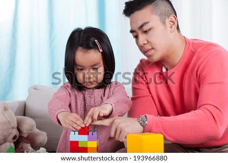 Brother and sister playing with colorful toys
