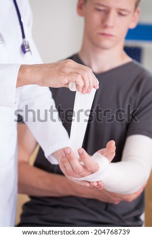 Man with broken hand at consulting room