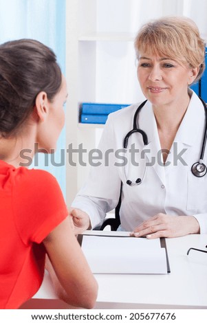 Lady doctor talking with a young patient