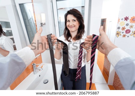 Wife choosing a tie for her man