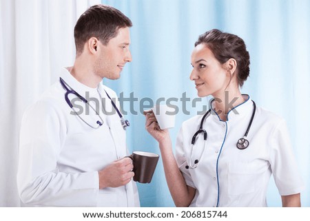 Young couple of doctors having coffee break