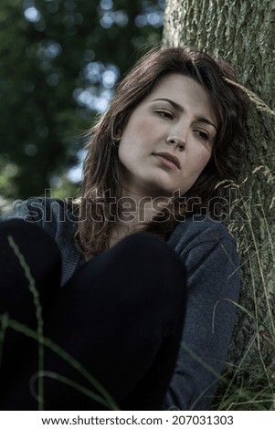 Portrait of a young depressed woman, vertical